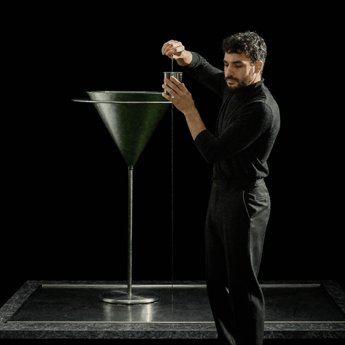 Kassem Kazal pours liquid metal from a small crucible into a large chrome funnel